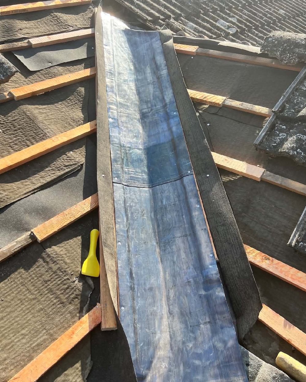 Lead valley during: new lead laid on fresh felt and battens